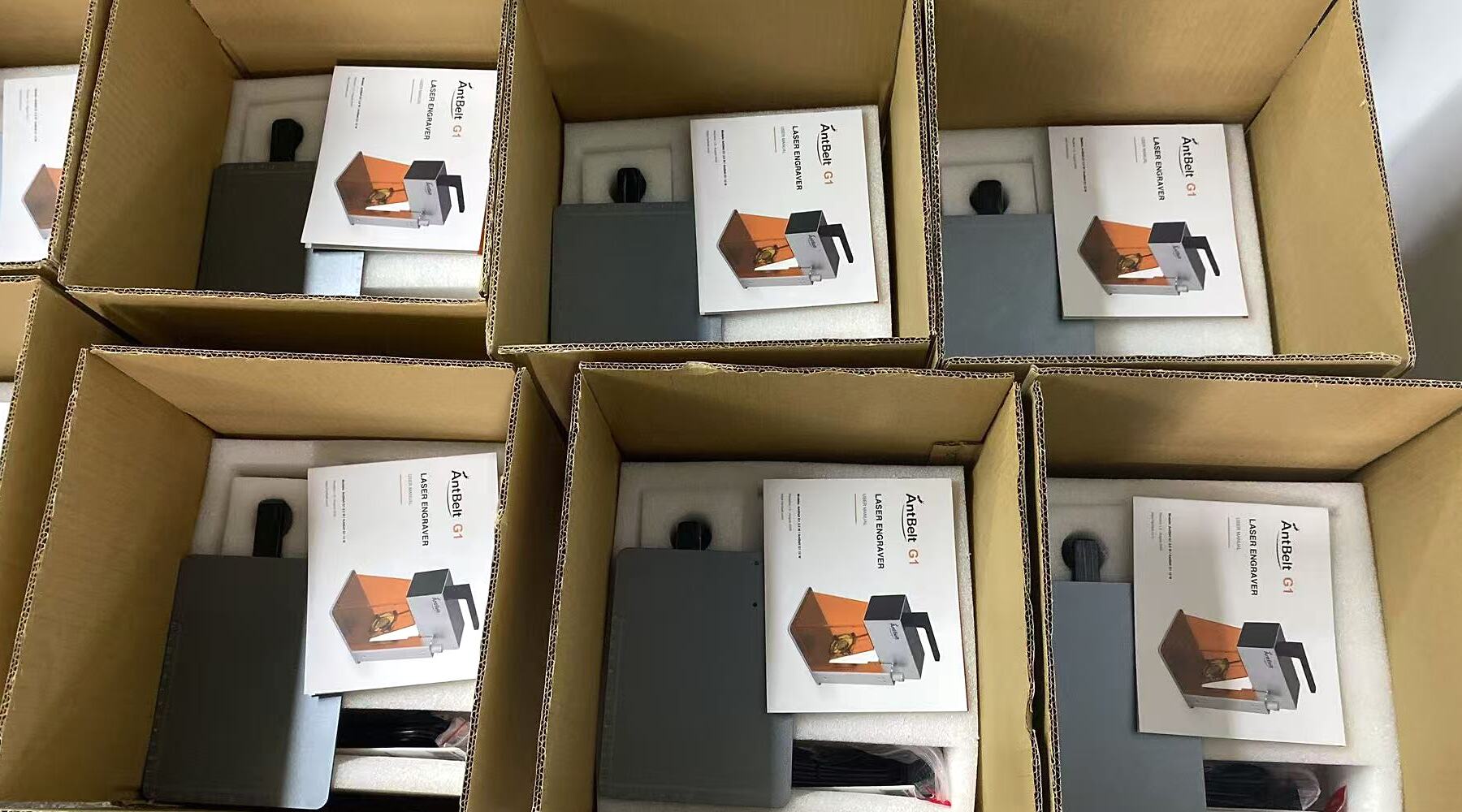 Open AntBelt G1 cartons showing completed units, protective foam and user manuals during fulfillment preparation