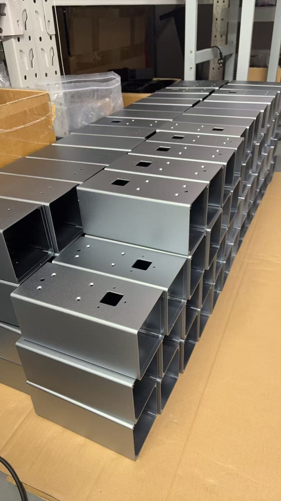 Multiple AntBelt G1 metal housings arranged together for batch assembly preparation